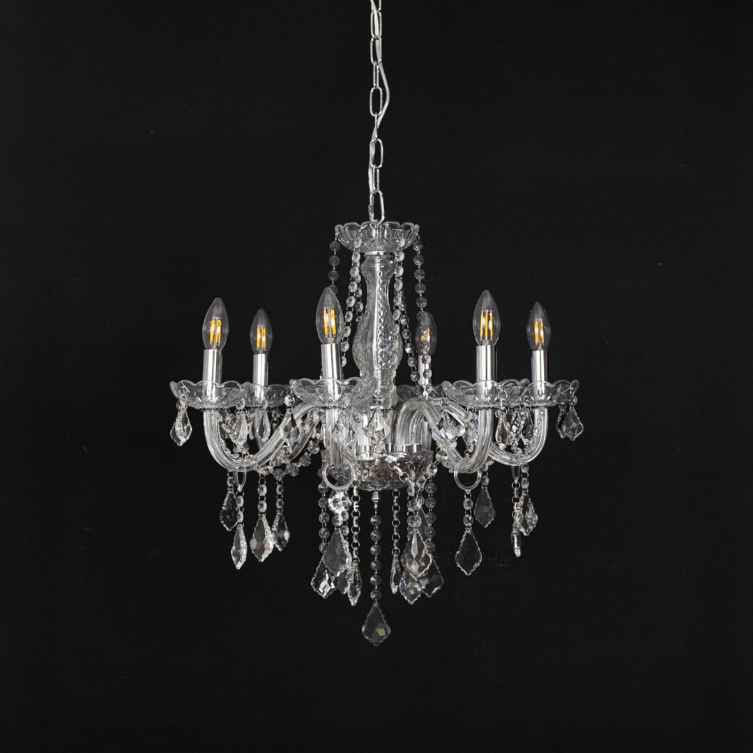 Chandelier with silver finish and crystal detailing displayed off against black background for interior style