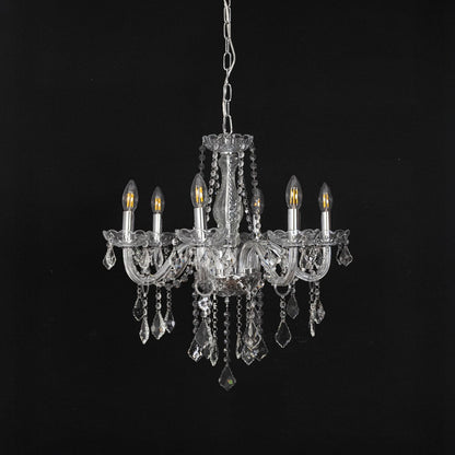 Chandelier with silver finish and crystal detailing displayed off against black background for interior style