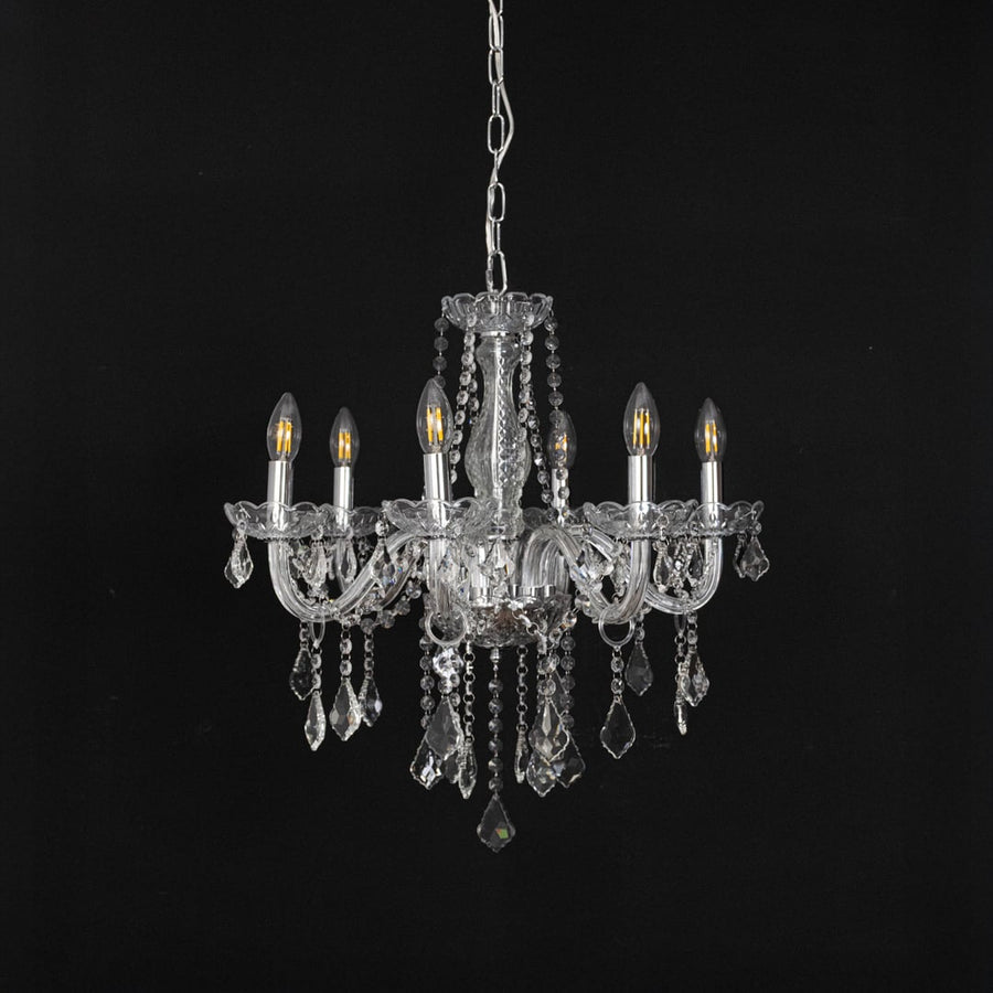 Chandelier with silver finish and crystal detailing displayed off against black background for interior style