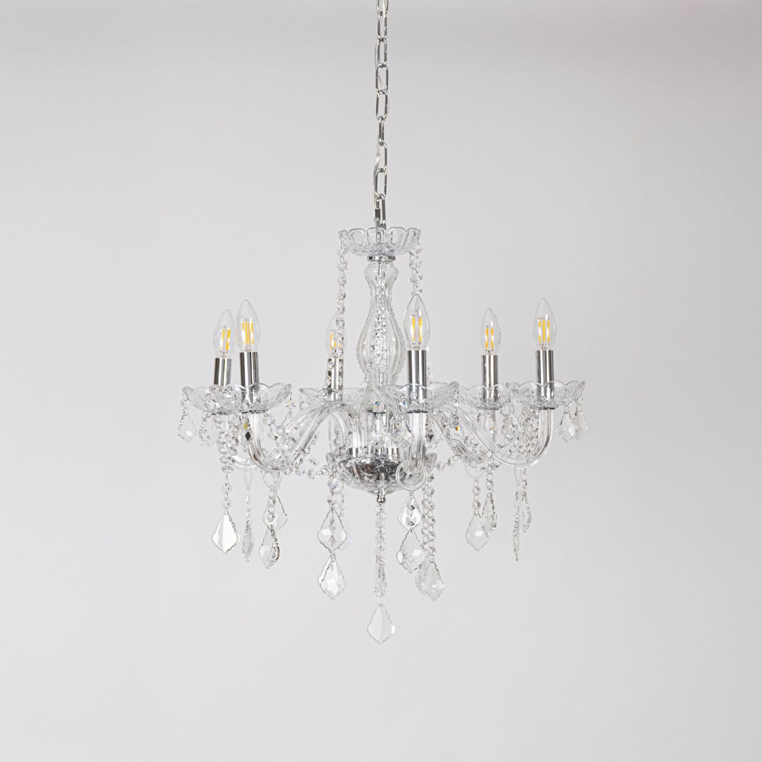 Classic chandelier with silver accents and crystal glass displayed off on white background for modern decor.