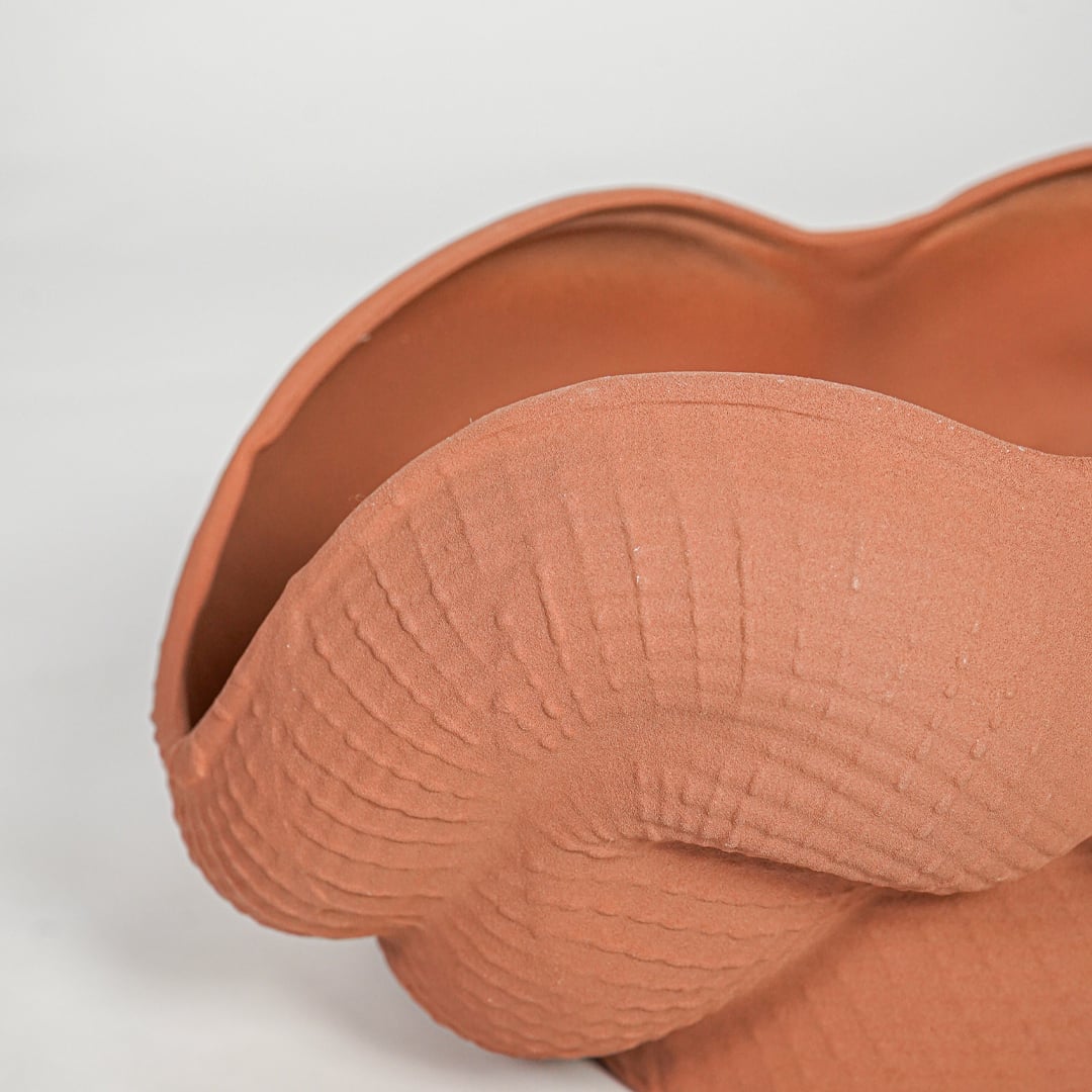 Textured orange ceramic bowl vase closeup modern decorative centerpiece for table console living room home decor styling.