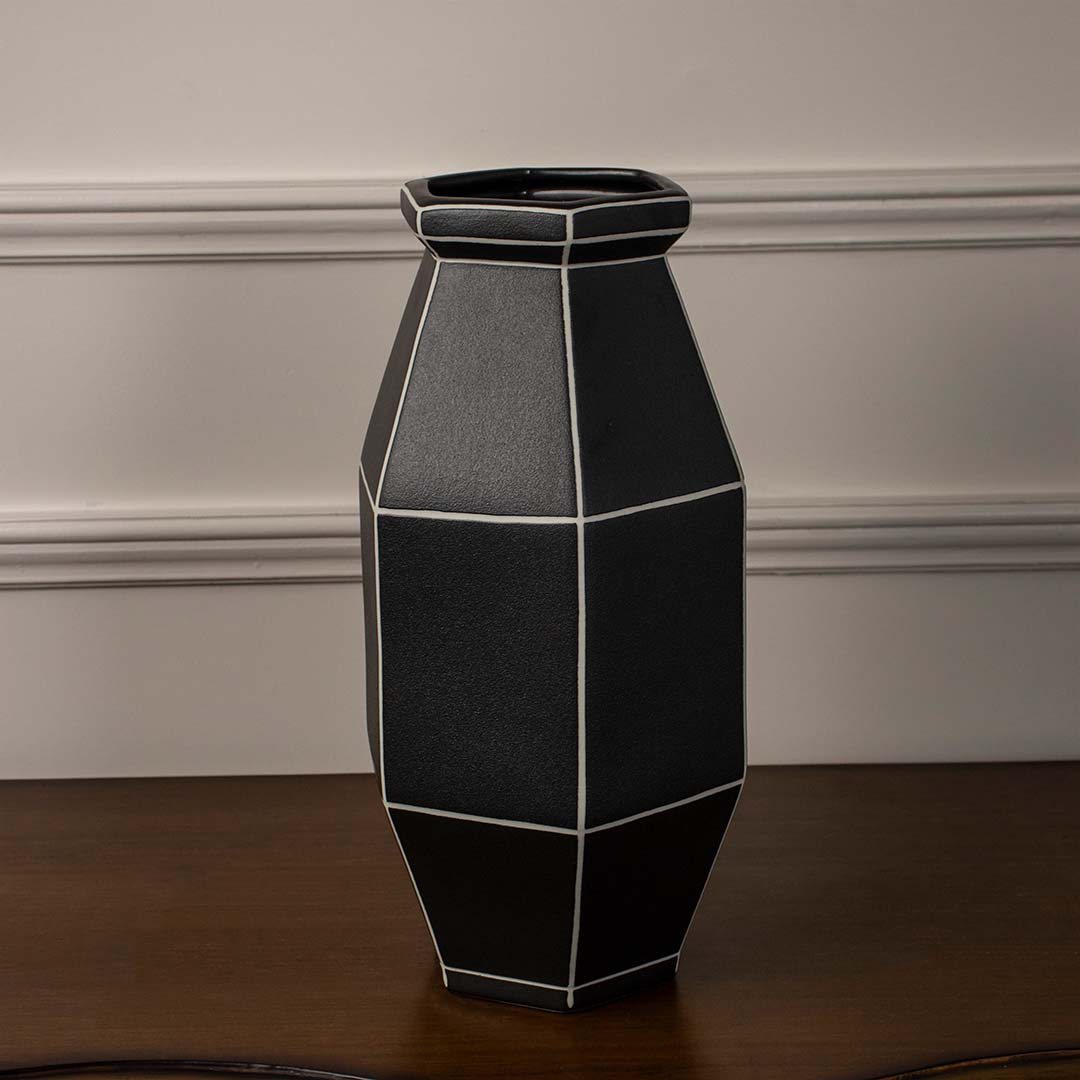 Black geometric ceramic decorative vase displayed on white background offering bold contemporary accent for shelf or console decor.