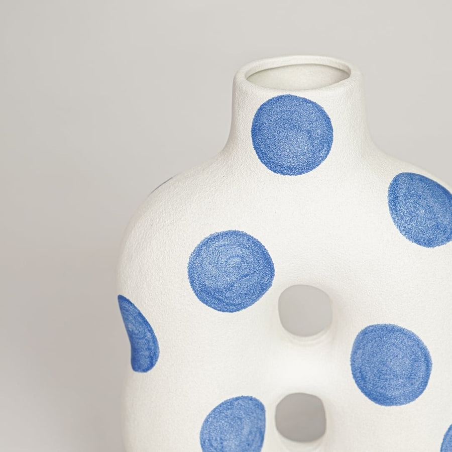 White ceramic decorative vase with blue dotted pattern and sculpted form perfect for elegant dried floral display and interior decor.
