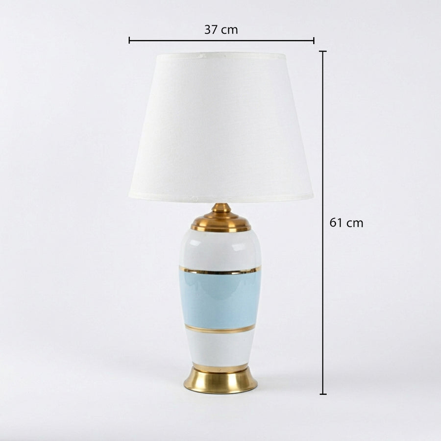 Table lamp with white fabric shade on white background minimal modern lighting suitable for bedroom and study decor.