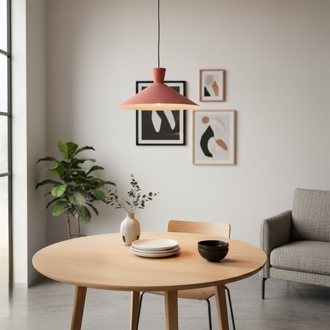 Terracotta metal pendant light above round table enhancing contemporary dining area with warm decorative lighting.