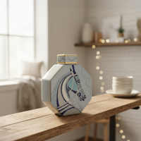 Blue and white ceramic decorative jar styled on a wooden console for elegant contemporary home decor settings.