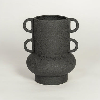 Modern black ceramic statement vase with rounded base and loop handles for coffee table console or shelf styling.