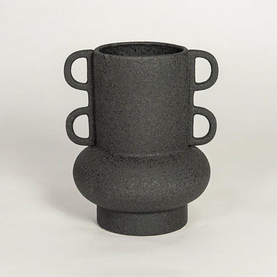Modern black ceramic statement vase with rounded base and loop handles for coffee table console or shelf styling.