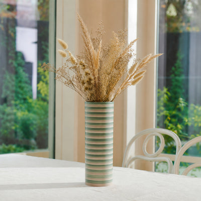 Lifestyle image of large green masih ceramic vase for elegant home interior decor styling and modern room table display.