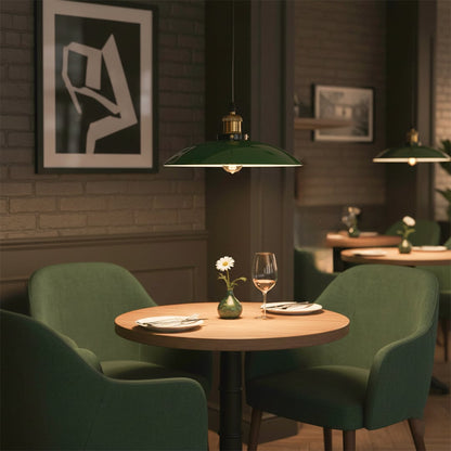 Green metal pendant light with brass accents enhancing contemporary dining room decor with inviting warmth.