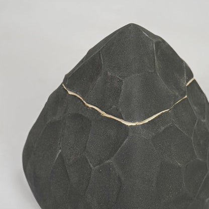 Closeup black textured decorative object surface detail modern ceramic decor piece for table shelf console styling.