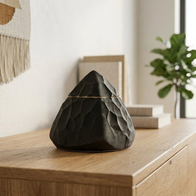 Black decorative ceramic showpiece placed on table modern artistic home decor styling idea.
