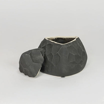Modern black decorative ceramic showpiece isolated clean background stylish home decor accent piece.