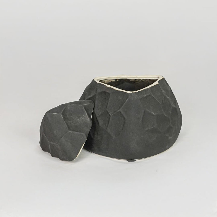 Modern black decorative ceramic showpiece isolated clean background stylish home decor accent piece.