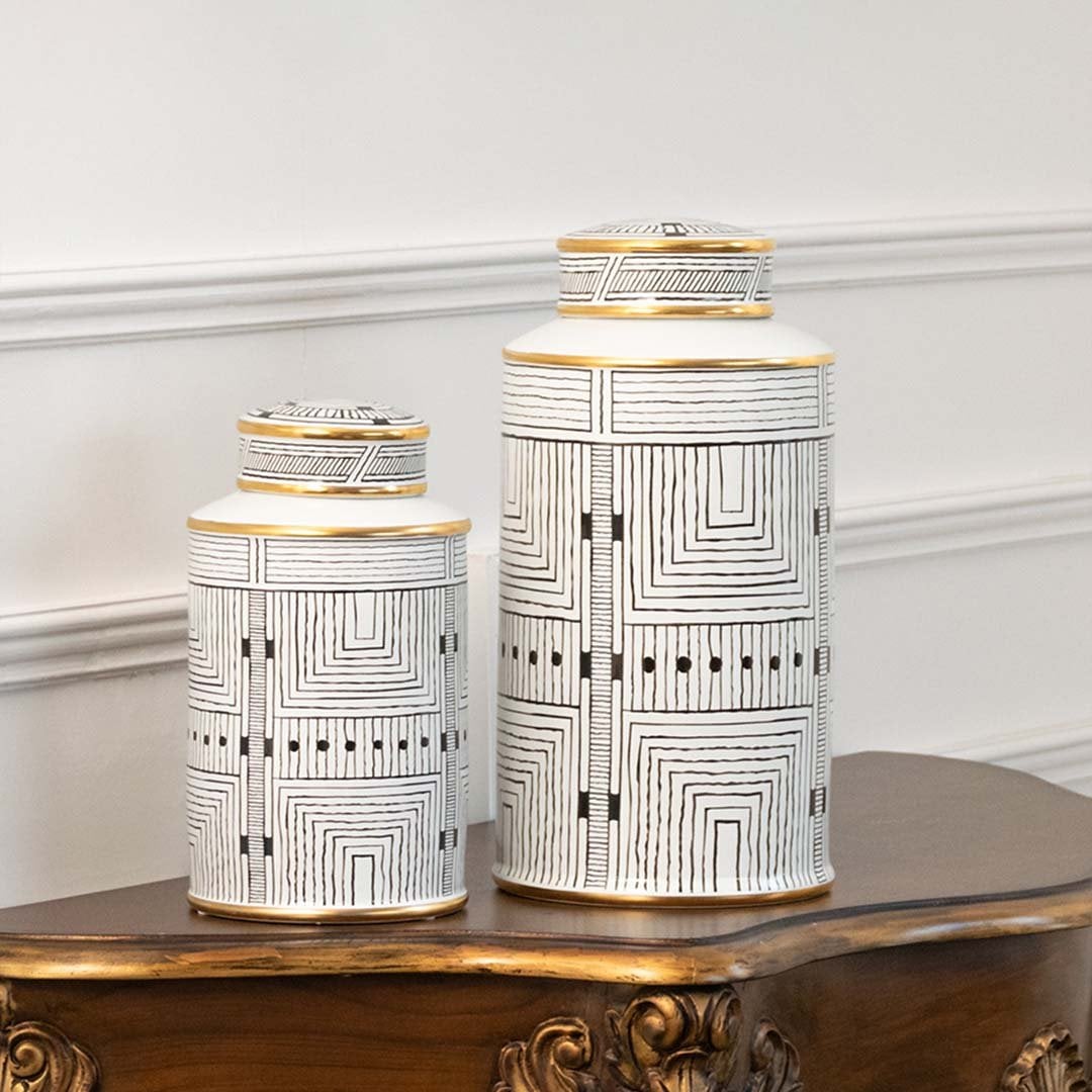 Pair of white jars with architectural artwork in a front view perfect for classic décor styling and elegant console placement.