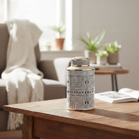 White ceramic decorative jar with black typography styled on a wooden table for elegant contemporary home decor settings.