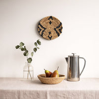 Lifestyle image of medieval touch handwoven sabai grass hanging wall basket for elegant home decor and modern room styling.