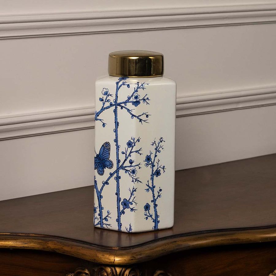 Square ceramic jar with blue floral butterfly design and golden lid crafted for modern luxury home decor styling