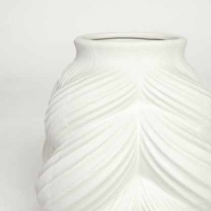 Close view of white ceramic sculpted vase highlighting layered leaf pattern and smooth matte finish.