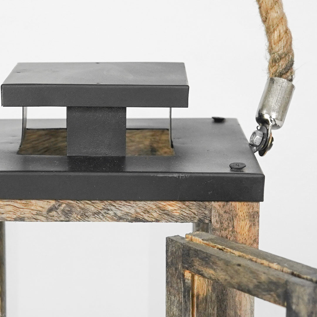 Close-up of a rustic wooden and metal bird feeder with a rope attachment.