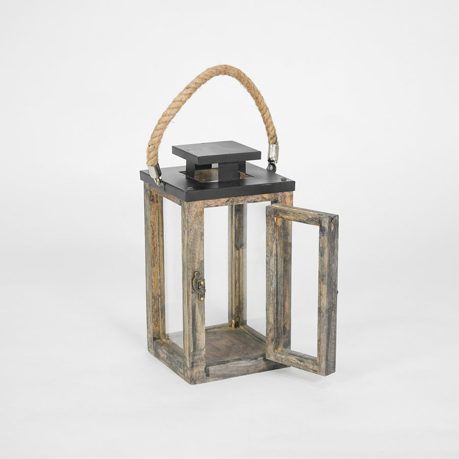 Wooden lantern with a black top and rope handle on a white background