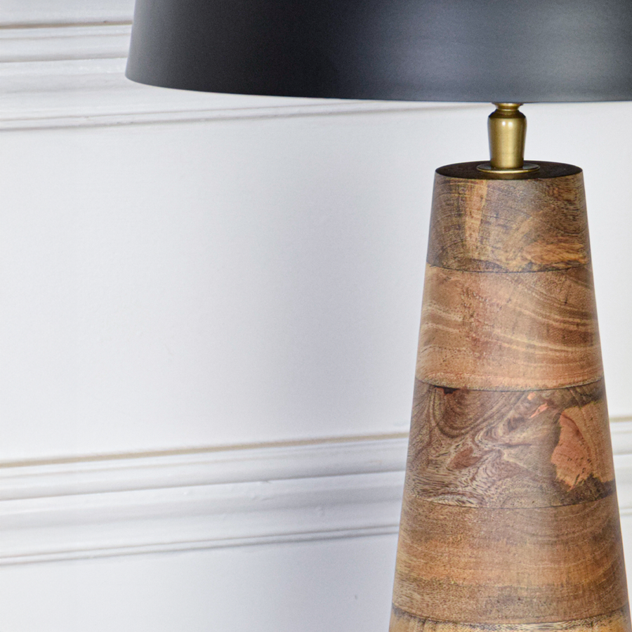 Table lamp closeup highlighting smooth black metal dome with rich wood grain base showcasing premium craftsmanship and refined modern design.