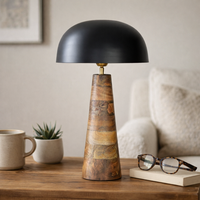 Table lamp styled table light on wooden surface with black dome shade and sculpted wood base creating warm modern luxury Decor for living room interiors.