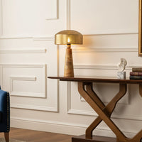 Table lamp placed on a wooden console table with classic wall paneling creating a warm elegant interior setting.