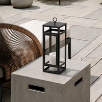 Minimalist black metal outdoor candle lantern for patio side table porch entryway seating area and garden terrace styling.