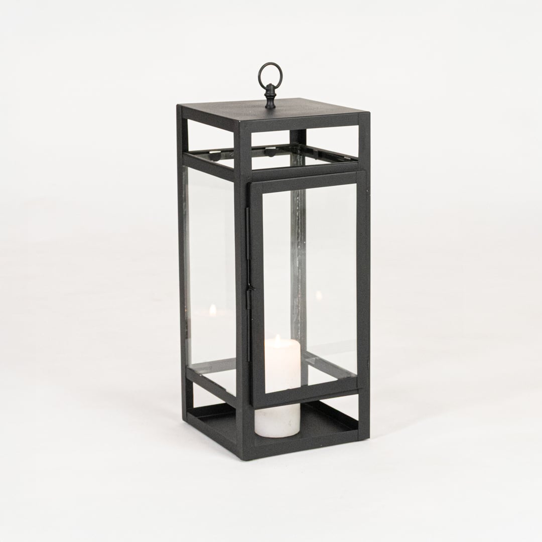 Minimal black metal candle lantern with transparent glass panels on white background perfect for home festive and patio Decor.