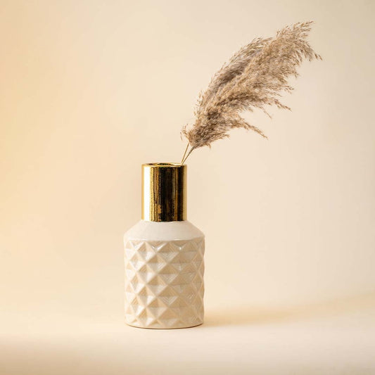 Textured white vase with gold neck and pampas grass for elegant modern home decor and refined interior style.