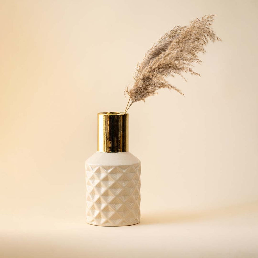 Textured white vase with gold neck and pampas grass for elegant modern home decor and refined interior style.