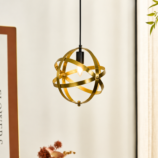 Lifestyle image of metallic gold globe hanging pendant light for elegant living room decor styling with polished finish.