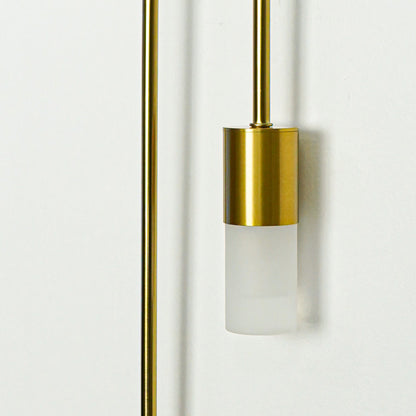 Closeup of gold metal wall light with frosted glass shade for modern bedroom hallway and living room decor.