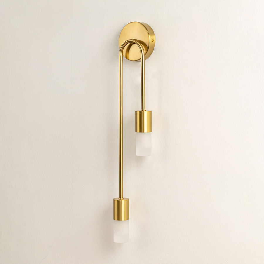 Elegant gold metal wall light mounted on white wall for stylish bedroom hallway and luxury interior decor styling.