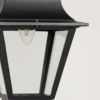 Contemporary black metal lantern pendant light with clear glass panels for stylish porch and patio lighting.