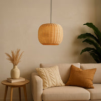 Natural woven rattan pendant light above sofa adding cozy bohemian warmth and timeless elegance.
