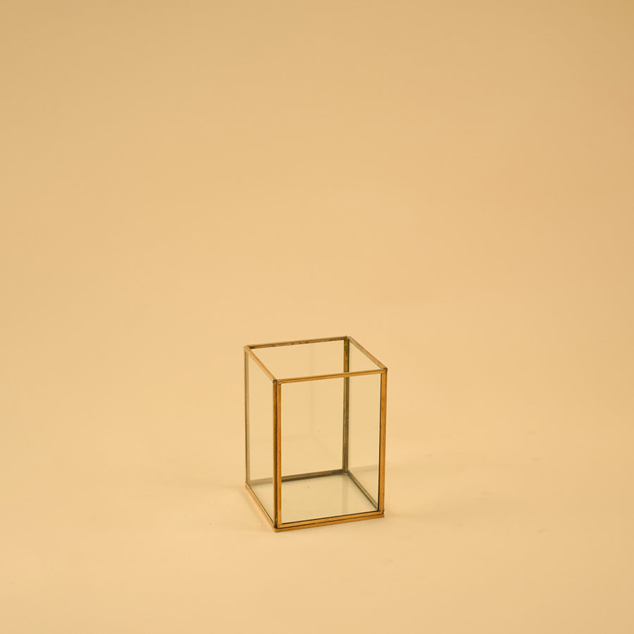 Simple rectangular brass framed glass vase for clean modern home decor and elegant minimalist tabletop accent styling.