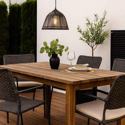 Black rattan pendant light glowing warmly against white background perfect for dining or living room decoration.