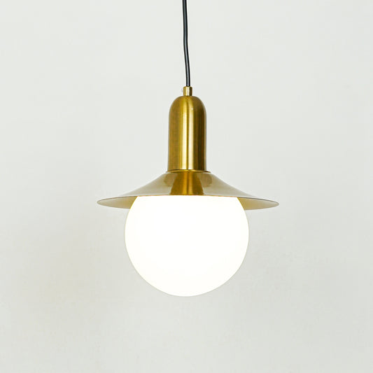 White glass globe pendant light with gold metal shade and hanging cord placed against neutral wall background showcasing elegant contemporary lighting design.