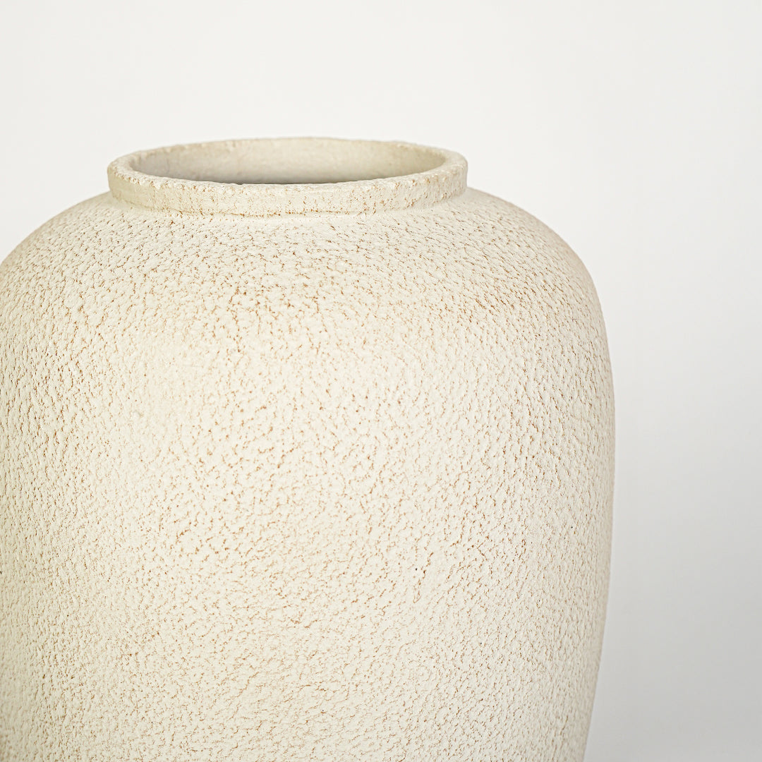 Closeup image of beige ceramic rustic vase for modern tabletop decor styling with artistic matte finish.