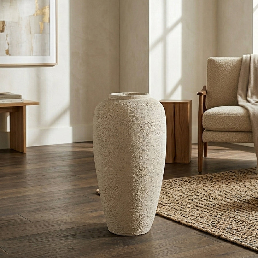 Lifestyle image of beige ceramic floor vase for modern living room decor styling with textured matte finish.