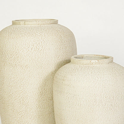 Closeup image of beige ceramic vase set for modern interior decor styling with textured matte finish.