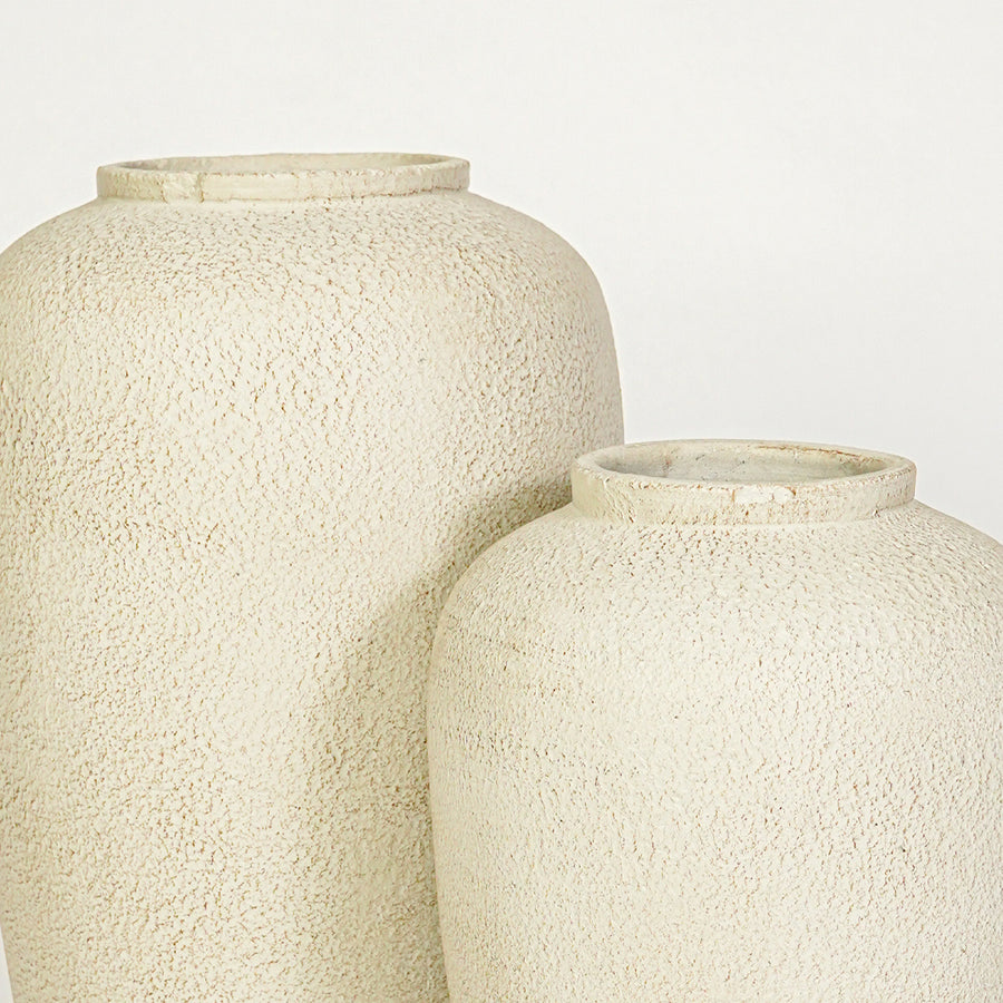 Closeup image of beige ceramic vase set for modern interior decor styling with textured matte finish.