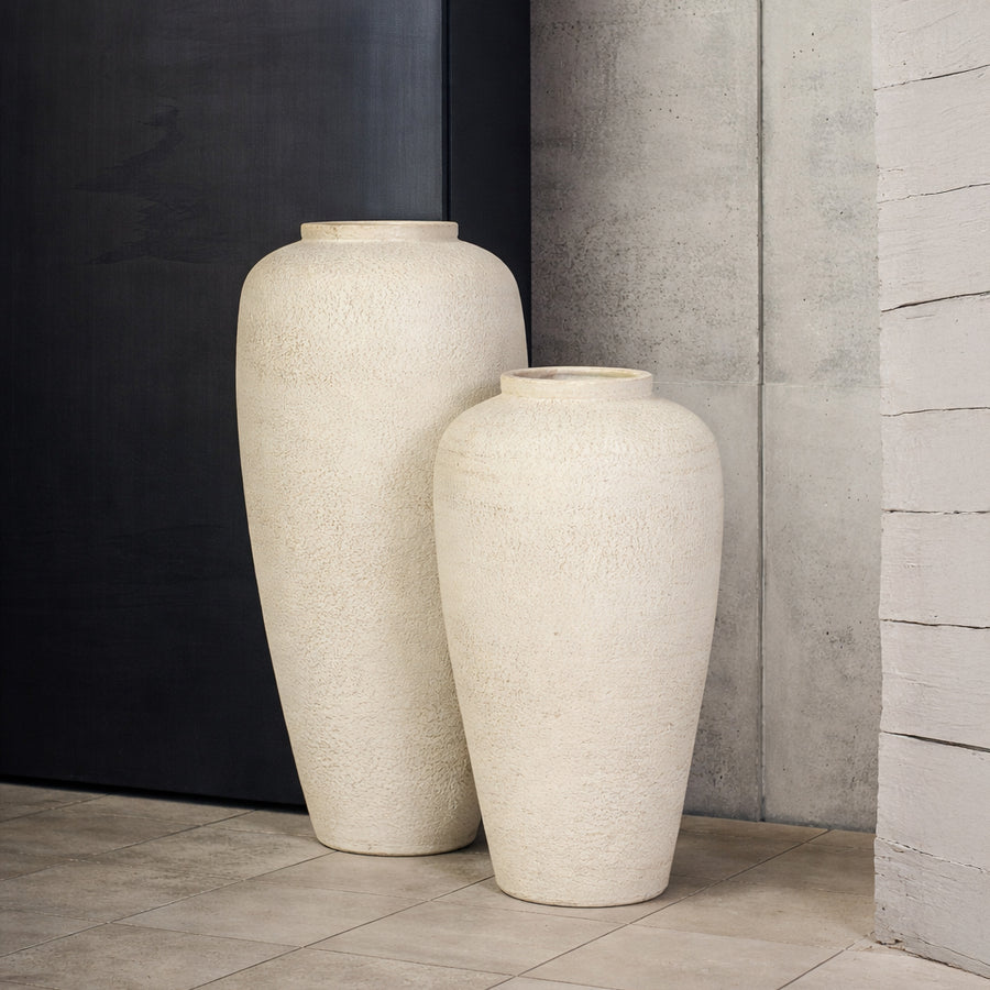 Lifestyle image of beige ceramic vase set for modern living room decor styling with textured matte finish.
