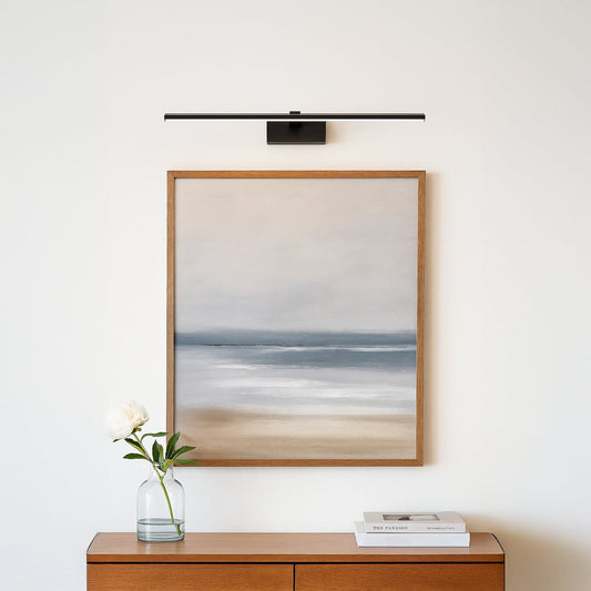 Contemporary black wall light mounted above mirror adding elegant illumination and modern aesthetic to interior decor.