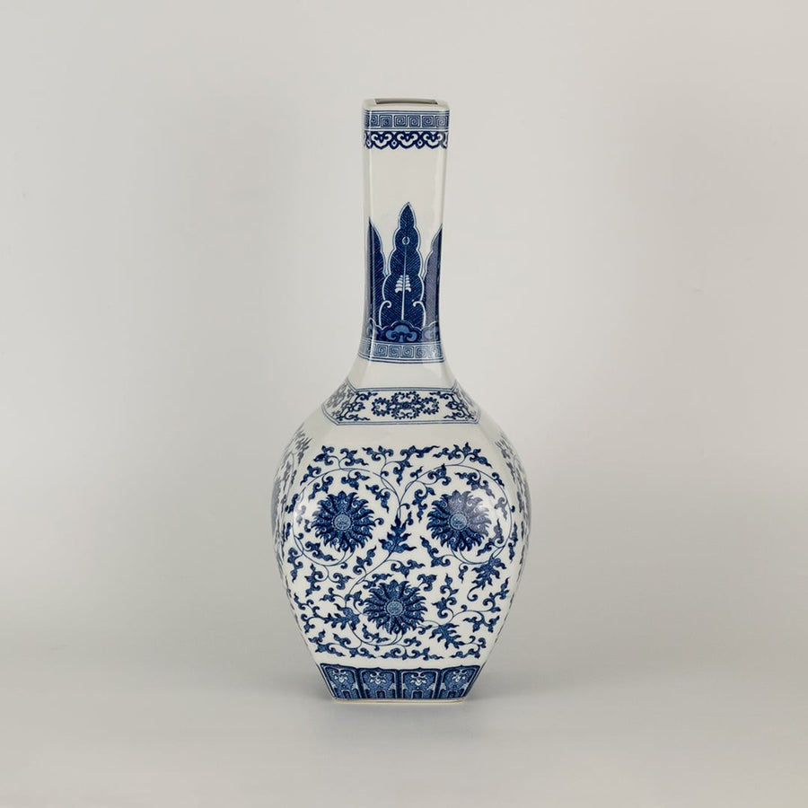 Blue and white ceramic jar with a tall narrow neck and intricate floral artwork shown in a studio setting creating a graceful artistic presence suited for elegant decor.