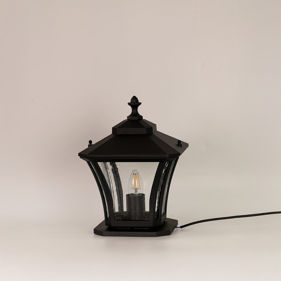 Black outdoor gate light with clear curved glass panels for stylish exterior decor styling use.