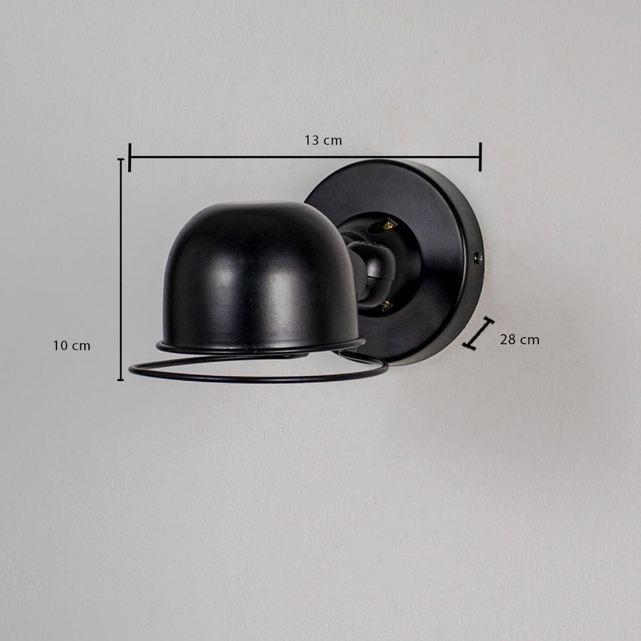 Wall light with matte black dome shade and cage detail shown with size 10 cm height 13 cm width and 28 cm depth.