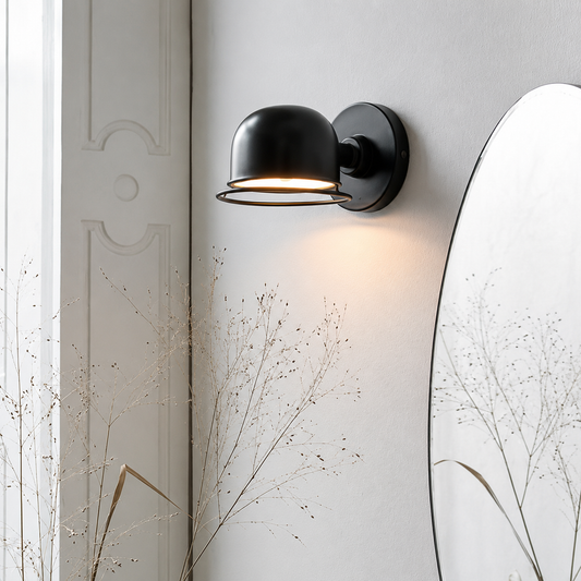 Lifestyle image of black mini domed metal wall lamp for elegant bedroom decor styling and modern home lighting.